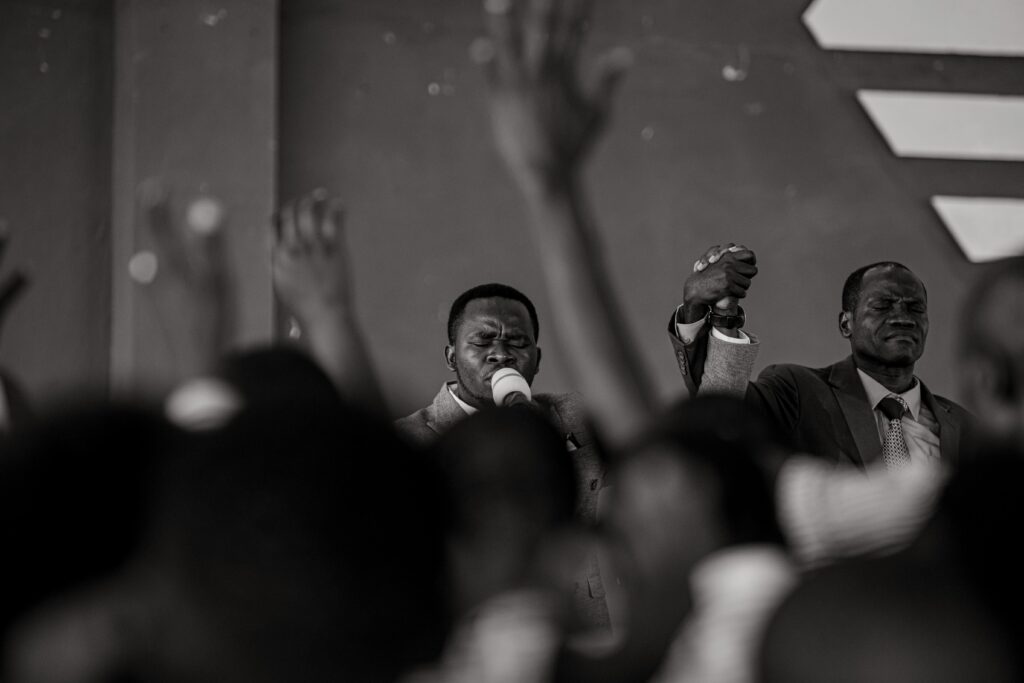 Grayscale Photo of a Man Preaching